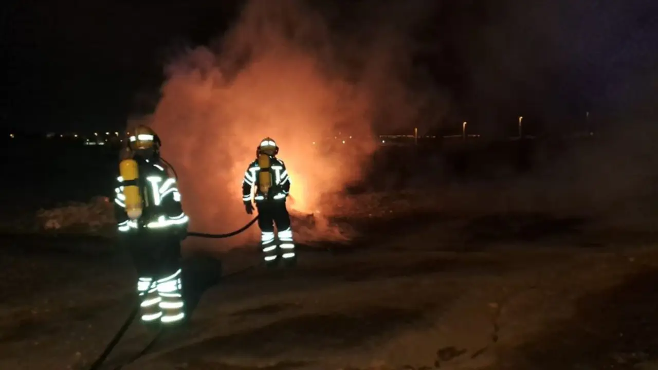 Los bomberos apagan el fuego de un contenedor